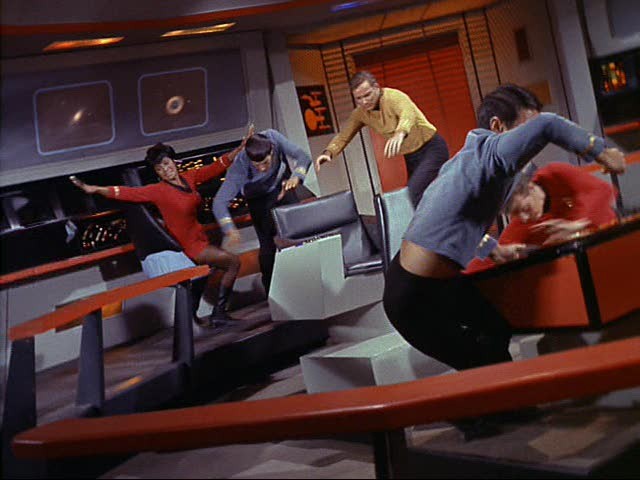 The original crew of the USS Enterprise flying across the bridge